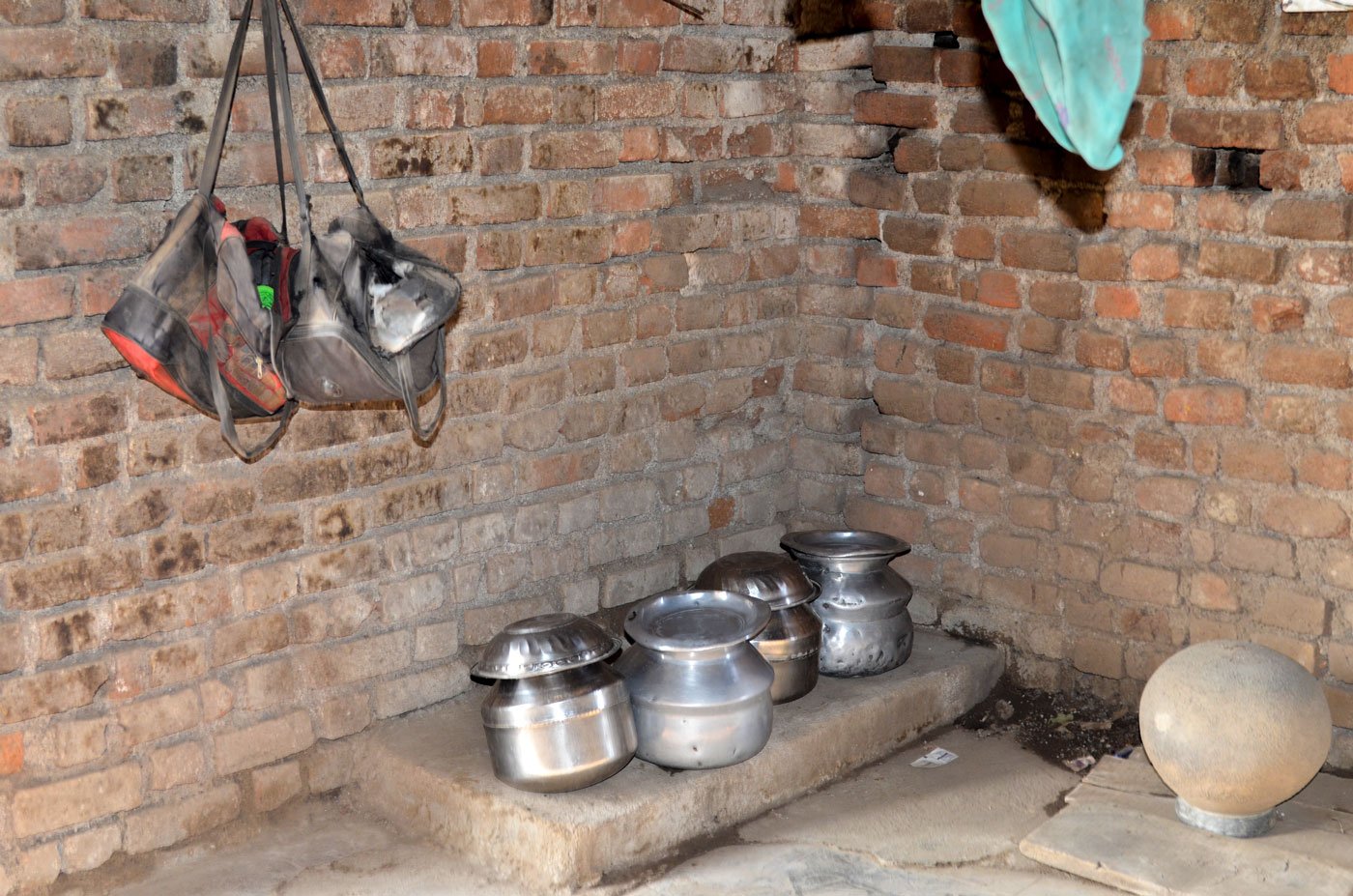 Utensils and the brick-lined stove in Shevanta's one-room home. She fears that her husband will marry again and then abandon her