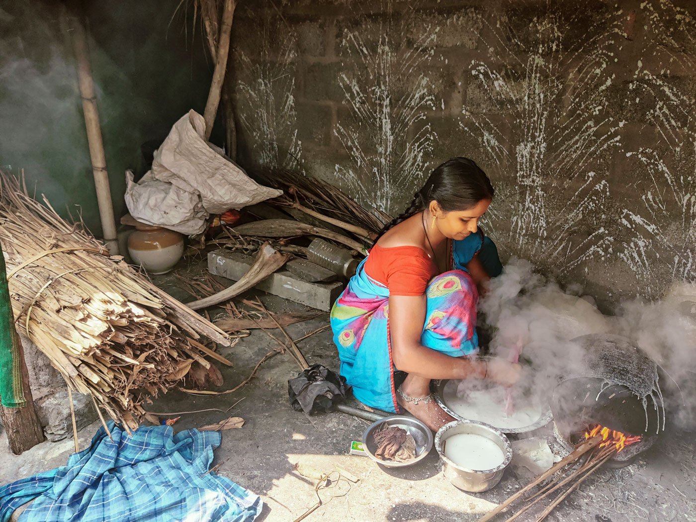 Left: Vijaya’s works in a small corner of her house. She calls this her workspace. It’s filled with the inverted pot, rice batter, dry coconut leaves and an old pickle jar amongst other things.