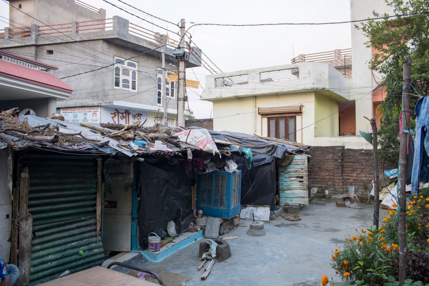 People in nearby buildings gave rations to the labourers living in the three rooms (left) in a back lane in Jammu city. Mohan Lal (right) resides in one of the rooms