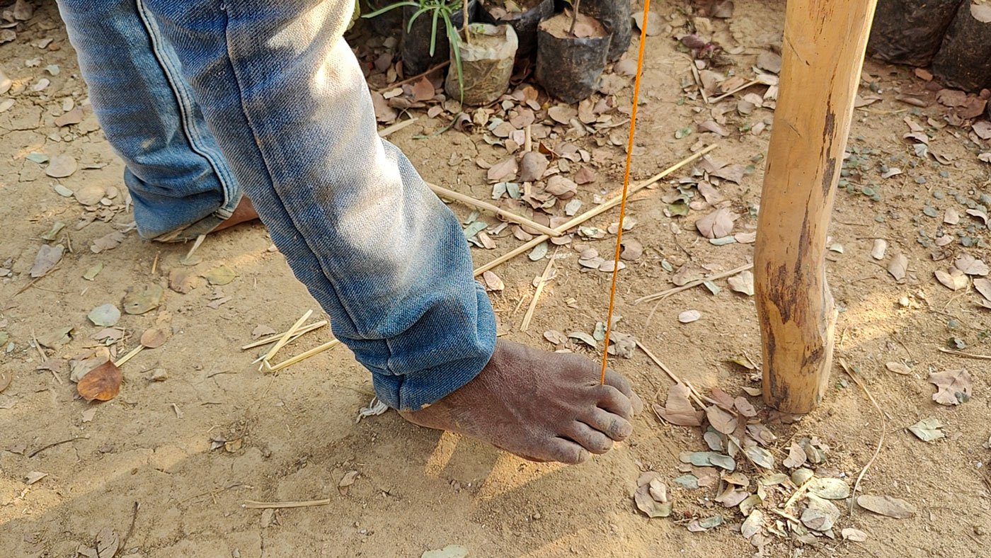 Right: Tapan Murmu skillfully moves the puppets with his feet