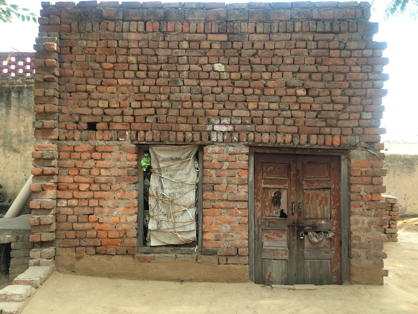 Aarifa: 'Using a contraceptive is considered a crime'; she had sprained her hand when we met. Right: The one-room house where she lives alone in Biwan