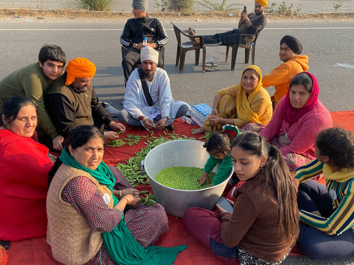 One of the youngest protestors at the Rajasthan-Haryana border pitches in to help his family prepare aloo mutter for a hundred people