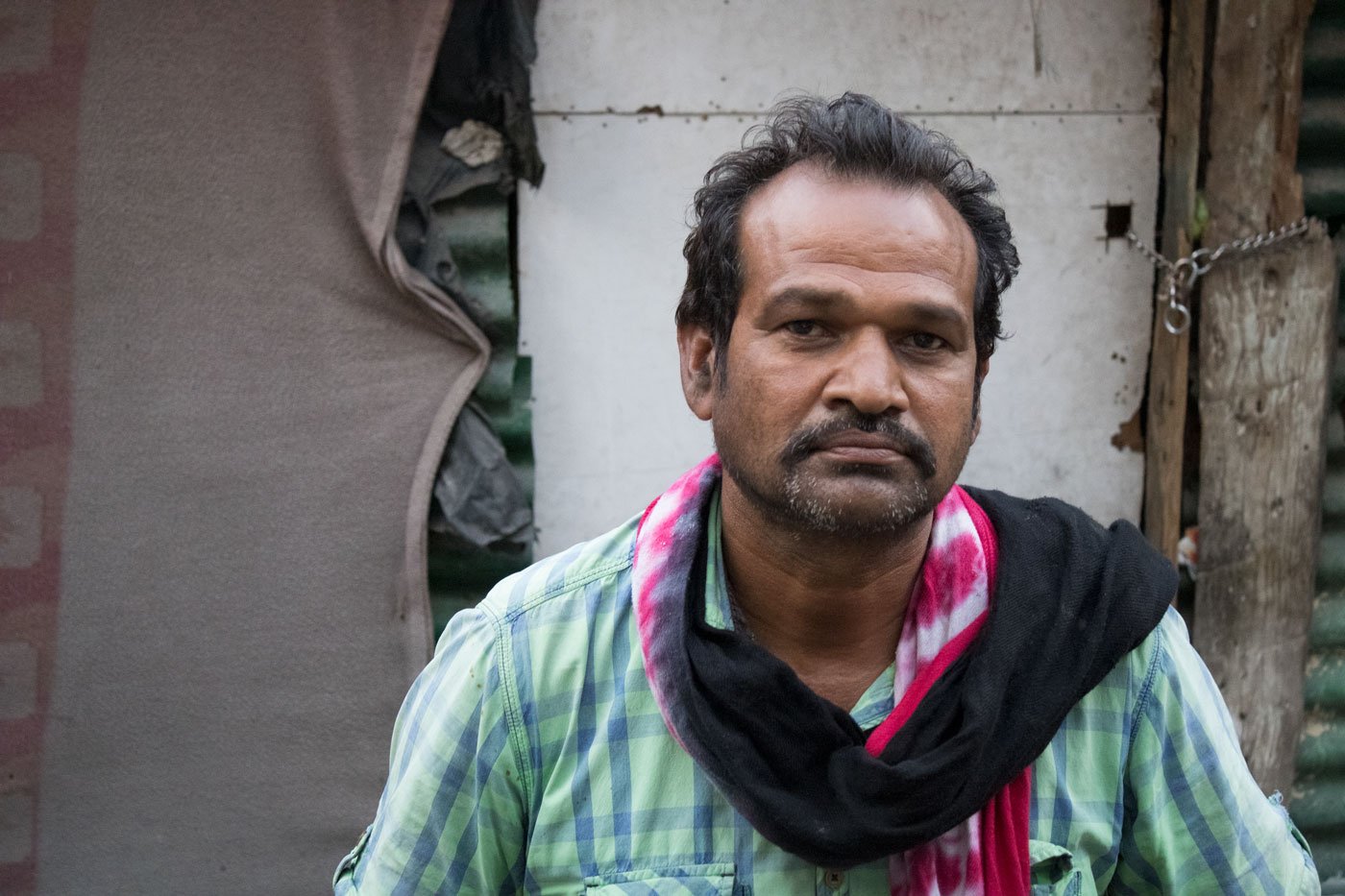 People in nearby buildings gave rations to the labourers living in the three rooms (left) in a back lane in Jammu city. Mohan Lal (right) resides in one of the rooms