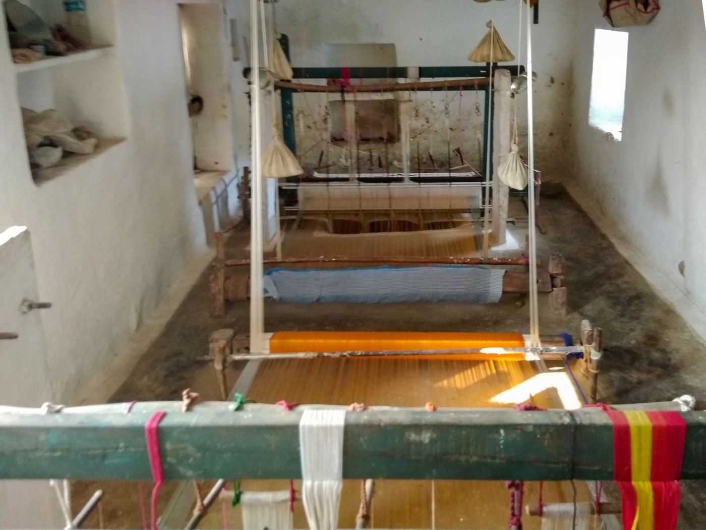 Left: A design card for a zari butti, given to Suresh by the seth to weave. Right: The two looms in Suresh and Shyambai's home face each other