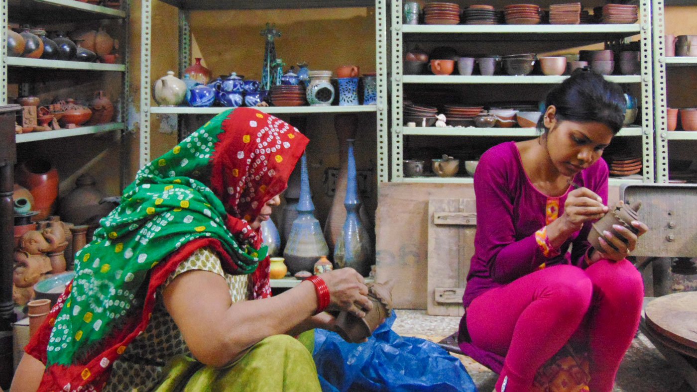 Narendra Prajapati (left): "...this virus has hit our work hard'. In Uttam Nagar, Ramrati and Rekha (right) have have been working on diyas but 'the joy is missing'