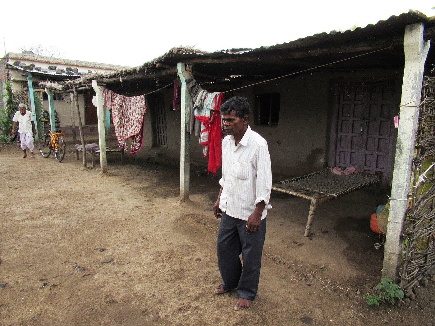 A man limping towards his home