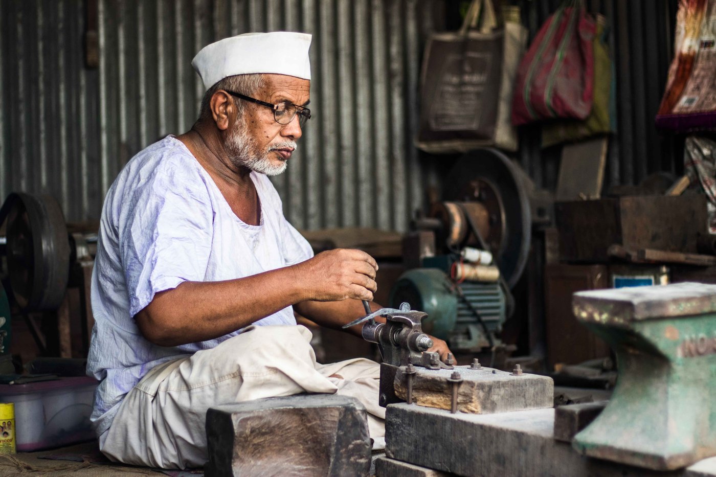Dilawar (left) meticulously files off swarfs once the nut cutter’s basic structure is ready; Salim hammers an iron rod to make the lower handle of an adkitta