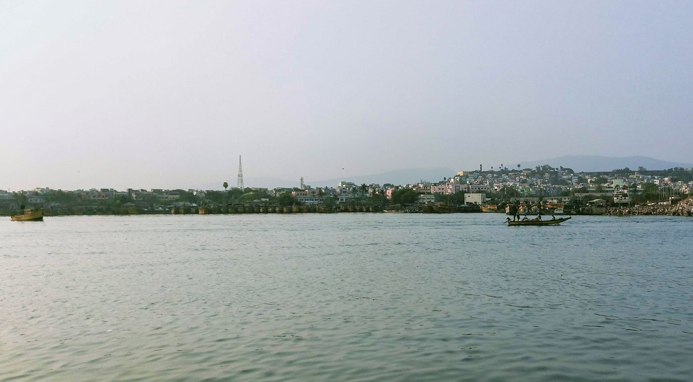 Left: The Fishing Harbour in Visakhapatnam (file photo). As of April 2, 2020, fishermen were officially not allowed to venture out to sea. Right: The police has been guarding the entrance to the jetty and fish market during the lockdown