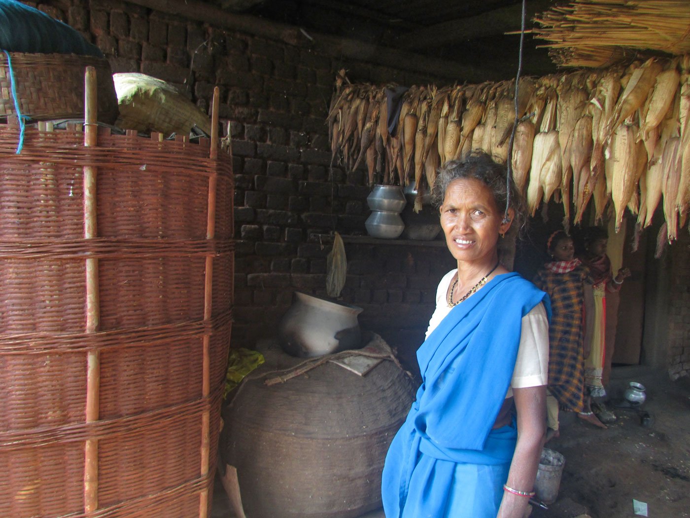 Kuleladu Jani (left) speaks of seed preservation in her home. Pramiti Majhi (centre) and other farmers (right) collecting seeds before returning home