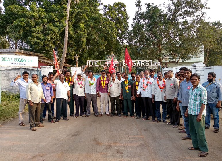 Workers protesting in front of the main entrance of the Delta Sugar Mills facing the National Highway 