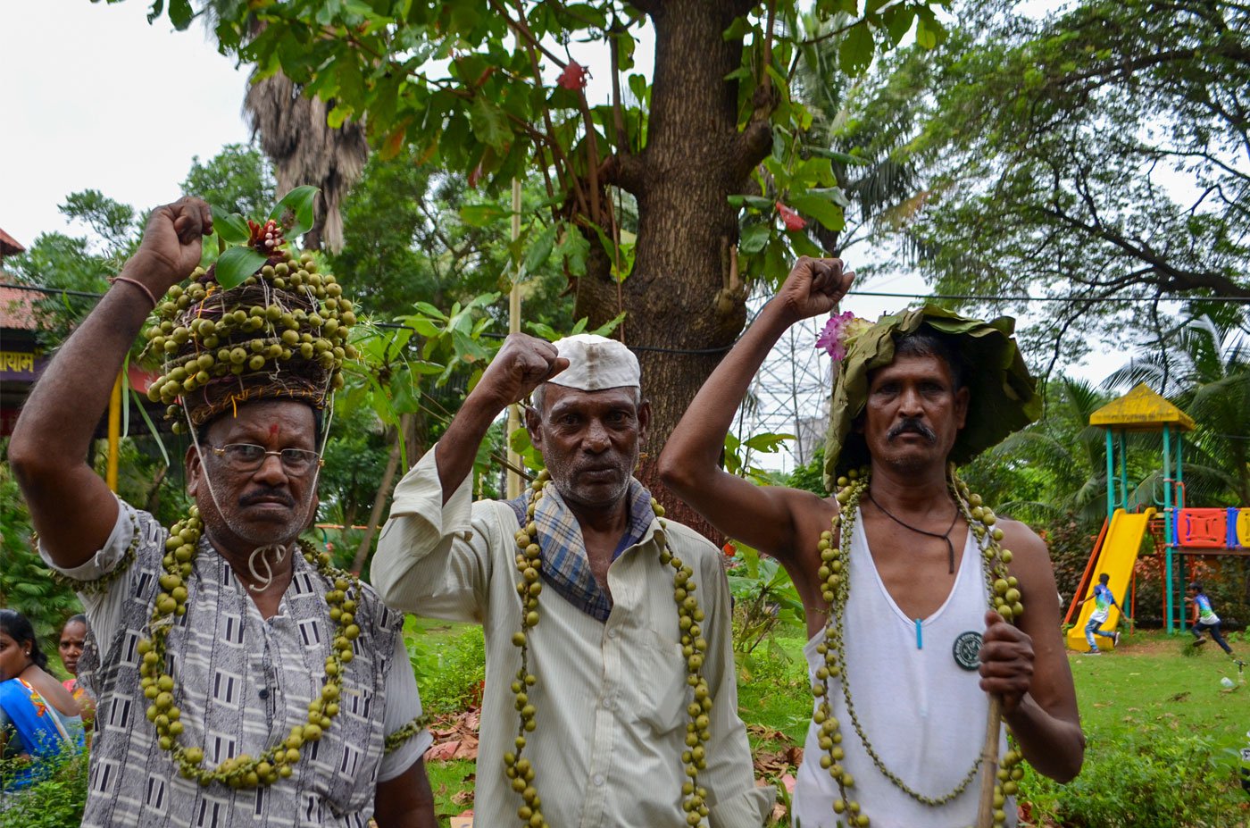 Right: Ladkya Dawde (left), Prabhu Thakar and Raghu wearing garlands of beral