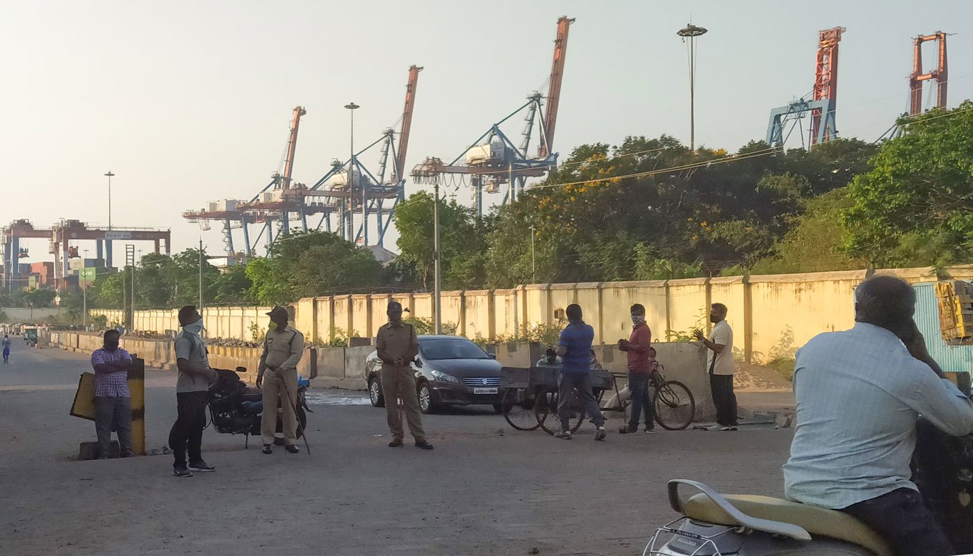 Left: The Fishing Harbour in Visakhapatnam (file photo). As of April 2, 2020, fishermen were officially not allowed to venture out to sea. Right: The police has been guarding the entrance to the jetty and fish market during the lockdown
