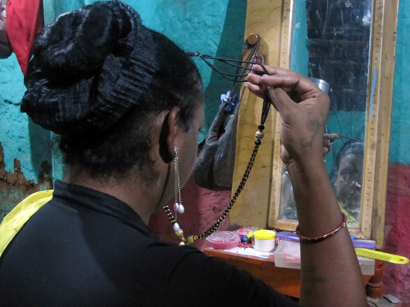 Radhika getting ready in a traditional saree and jewellery for her daily round of the markets to ask for money
