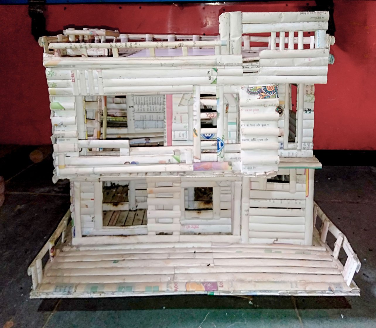 He looks for houses that have some ornamentation. This design (right) was inspired by the house (left) of a local teacher who gave him waste notebooks