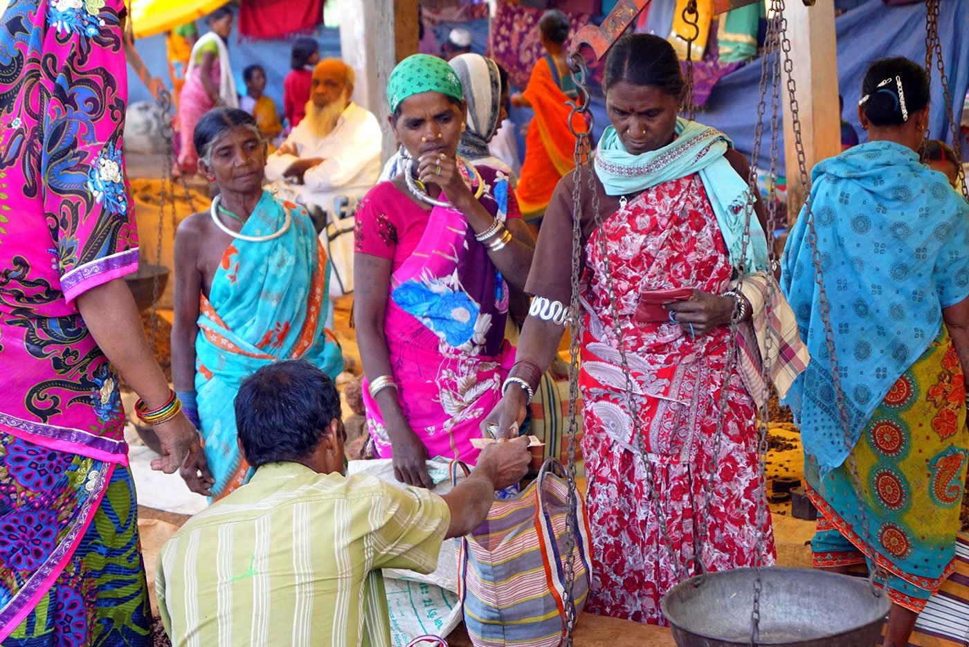 Women sell forest produces, including mahua flowers and lac (a natural resin) to a trader.