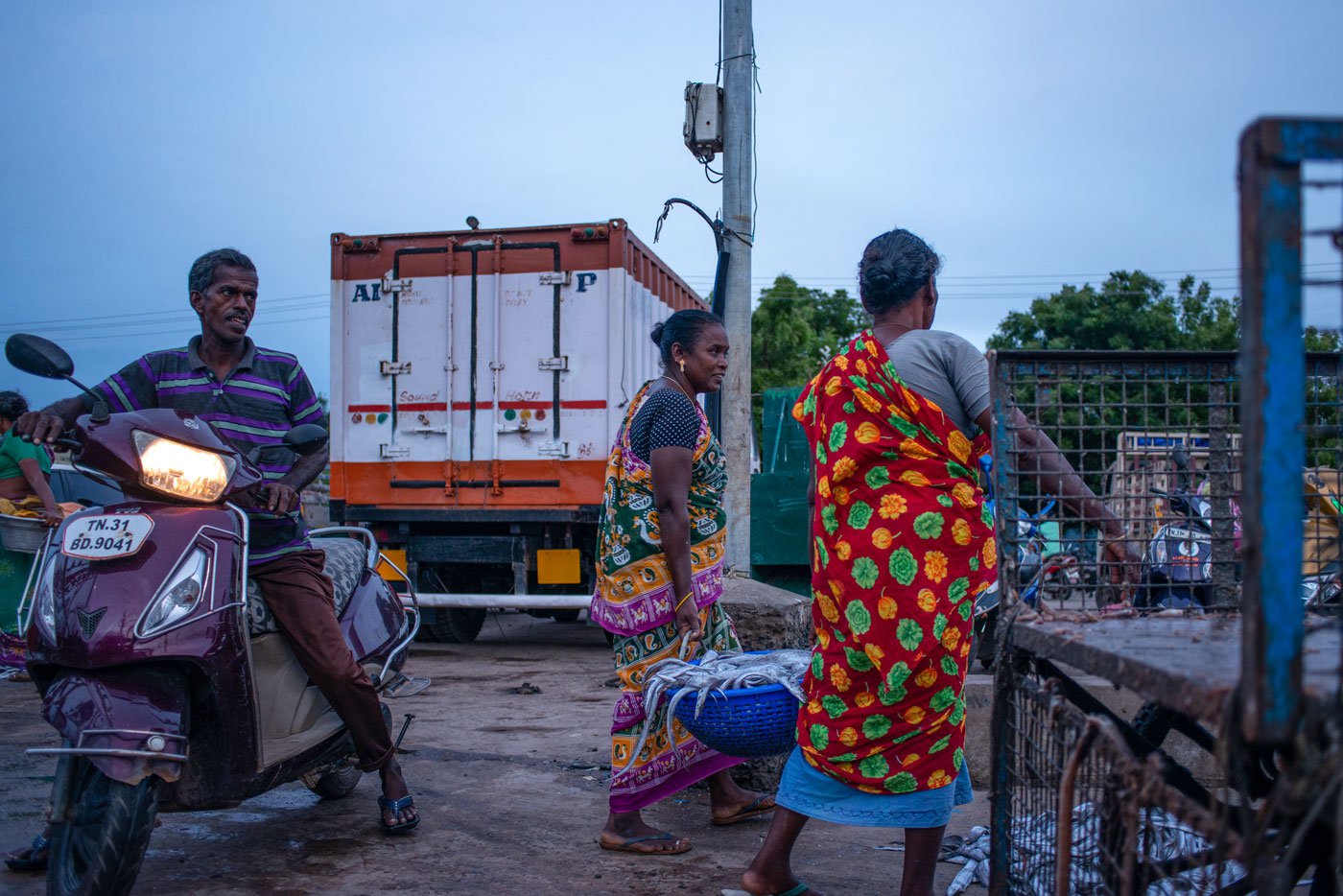 Visalatchi with one of her workers carrying freshly purchased fish. She paid  the workers a daily wage of Rs. 300 with lunch and tea