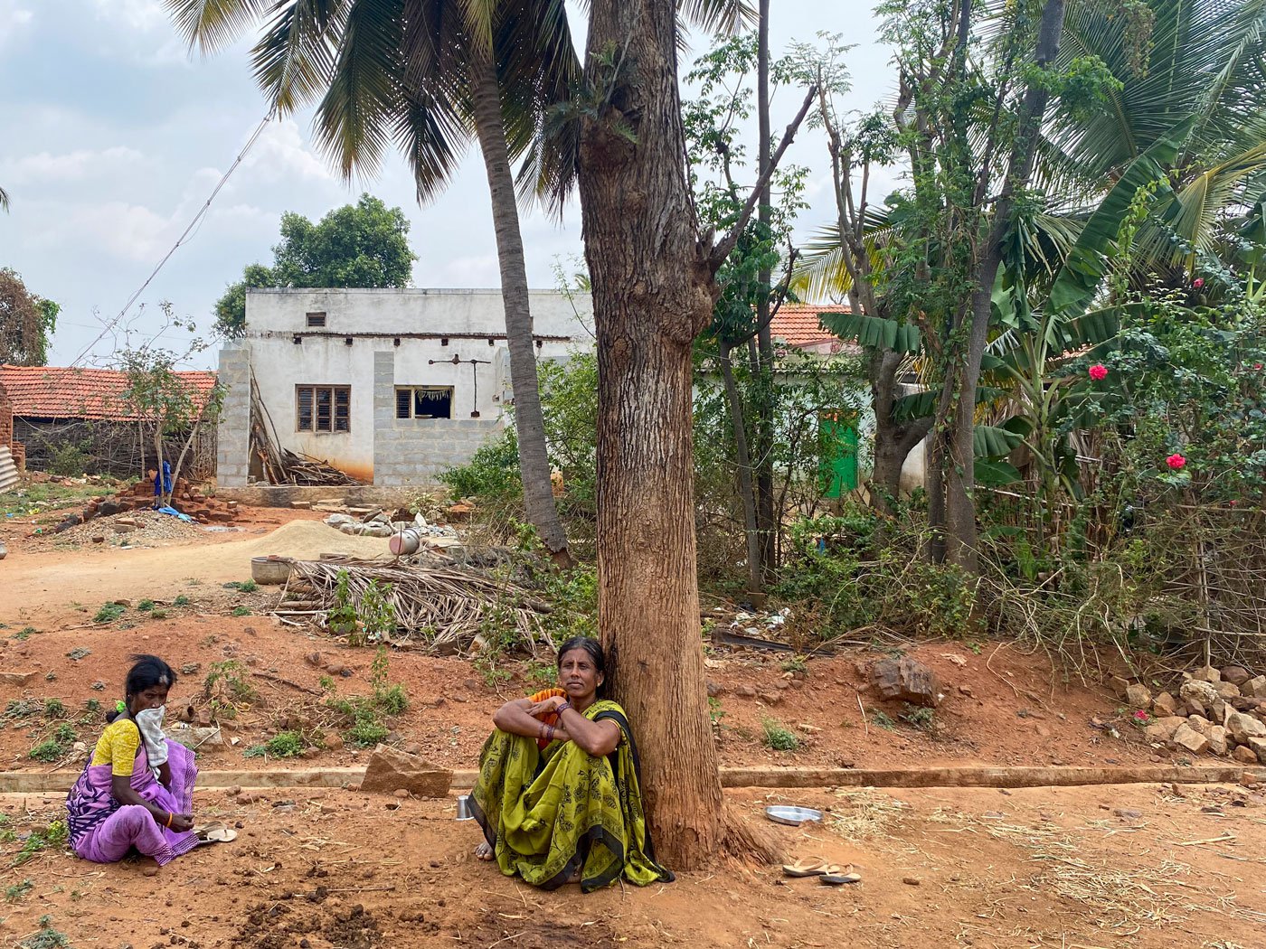 Jayamma (left) sits and sleeps under this tree in the Kadugolla hamlet of D. Hosahalli during her periods. Right: D. Hosahalli grama panchayat president Dhanalakshmi K. M. says, ' I’m shocked to see that women are reduced to such a level'