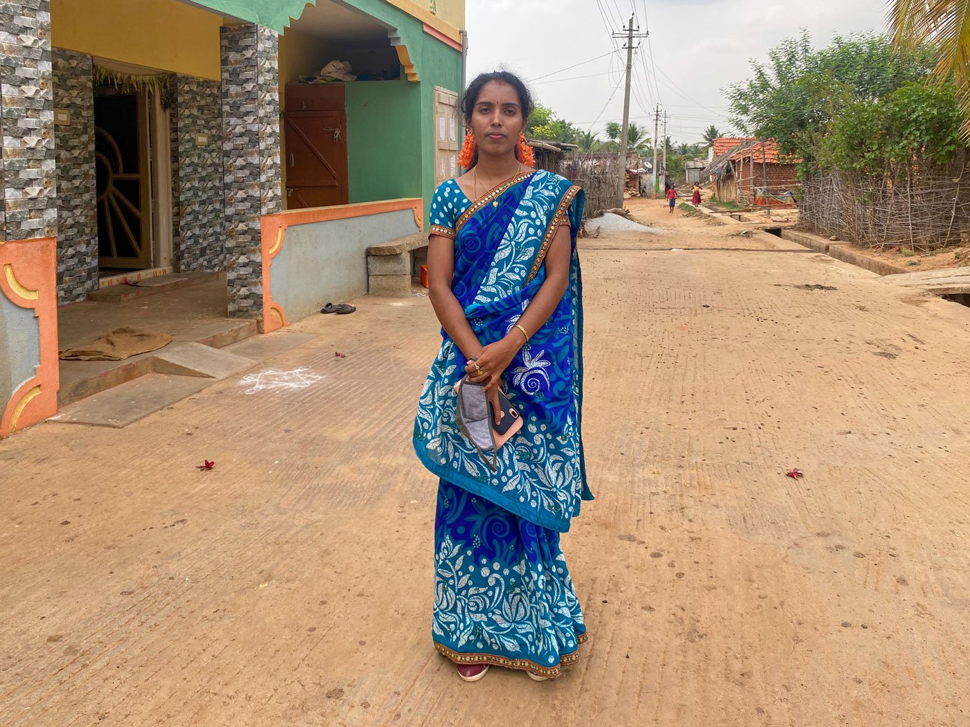 Jayamma (left) sits and sleeps under this tree in the Kadugolla hamlet of D. Hosahalli during her periods. Right: D. Hosahalli grama panchayat president Dhanalakshmi K. M. says, ' I’m shocked to see that women are reduced to such a level'