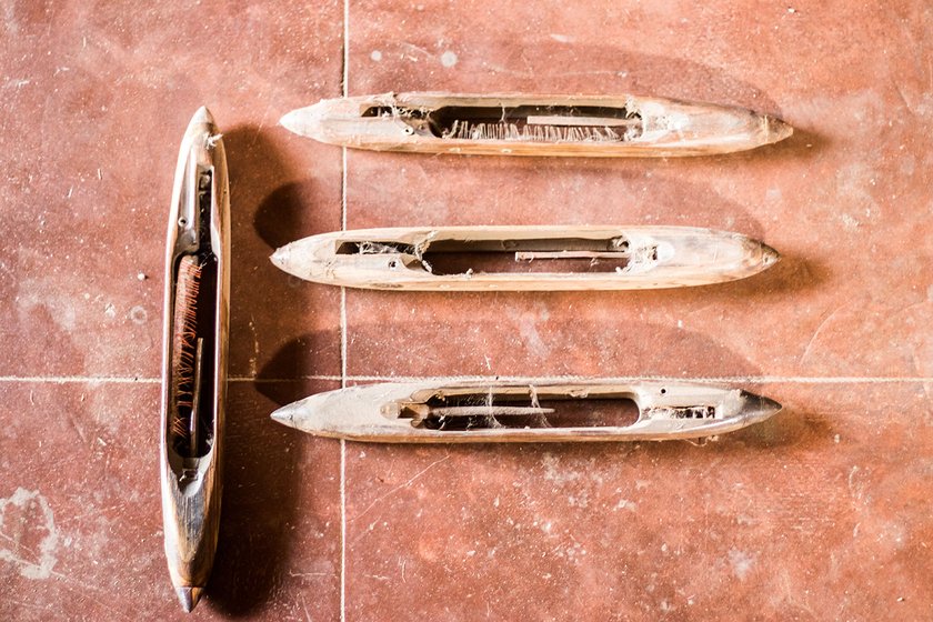 The shuttle which carries the pirn moves back and forth and helps in interweaving the yarn to produce the cloth