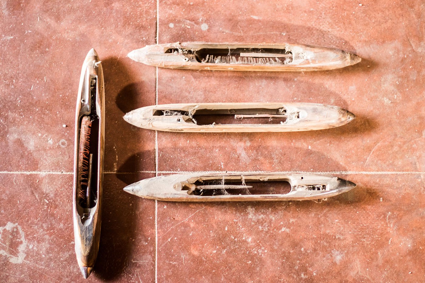 The shuttle which carries the pirn moves back and forth and helps in interweaving the yarn to produce the cloth