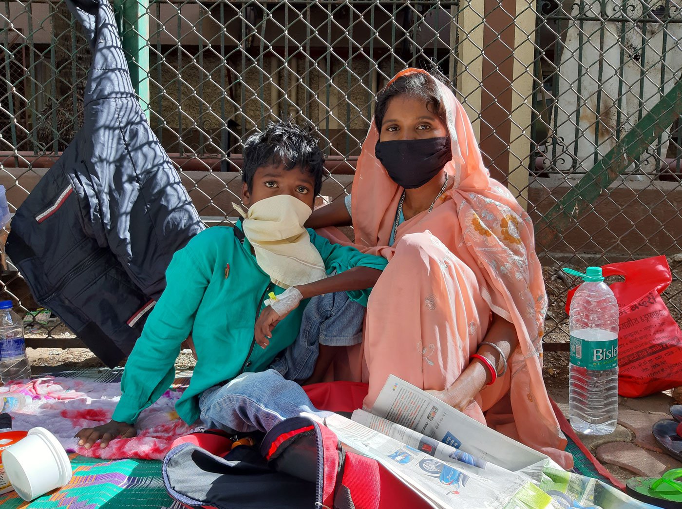 Left: Ajay , a Class 4 student from Jharkhand, arrived in Mumbai with his parents over two weeks ago. Ajay suffers from blood cancer. His father runs around for his reports and medicines while his mother takes care of him on the footpath. Right: People from poor families across India come to the Tata Memorial Hospital because it provides subsidised treatment to cancer patients