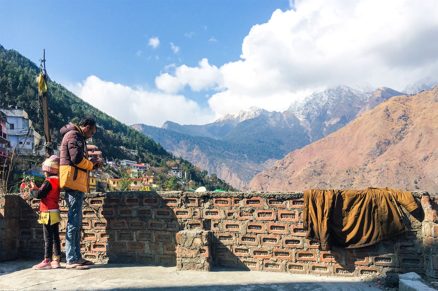 Raghav and Ayesha on the terrace of their home. 'I want to come again to sit in the sun on my roof and watch the mountains'.