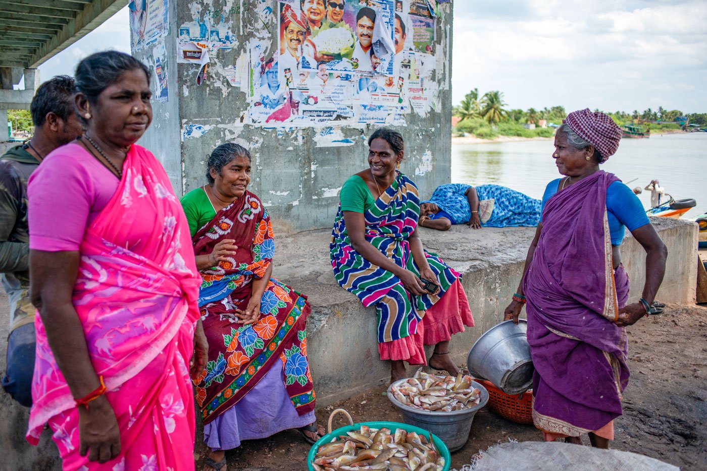 Left: Maneesha waits with other women for the fish auction to begin. Right: All sellers leave the bridge around 5 p.m.