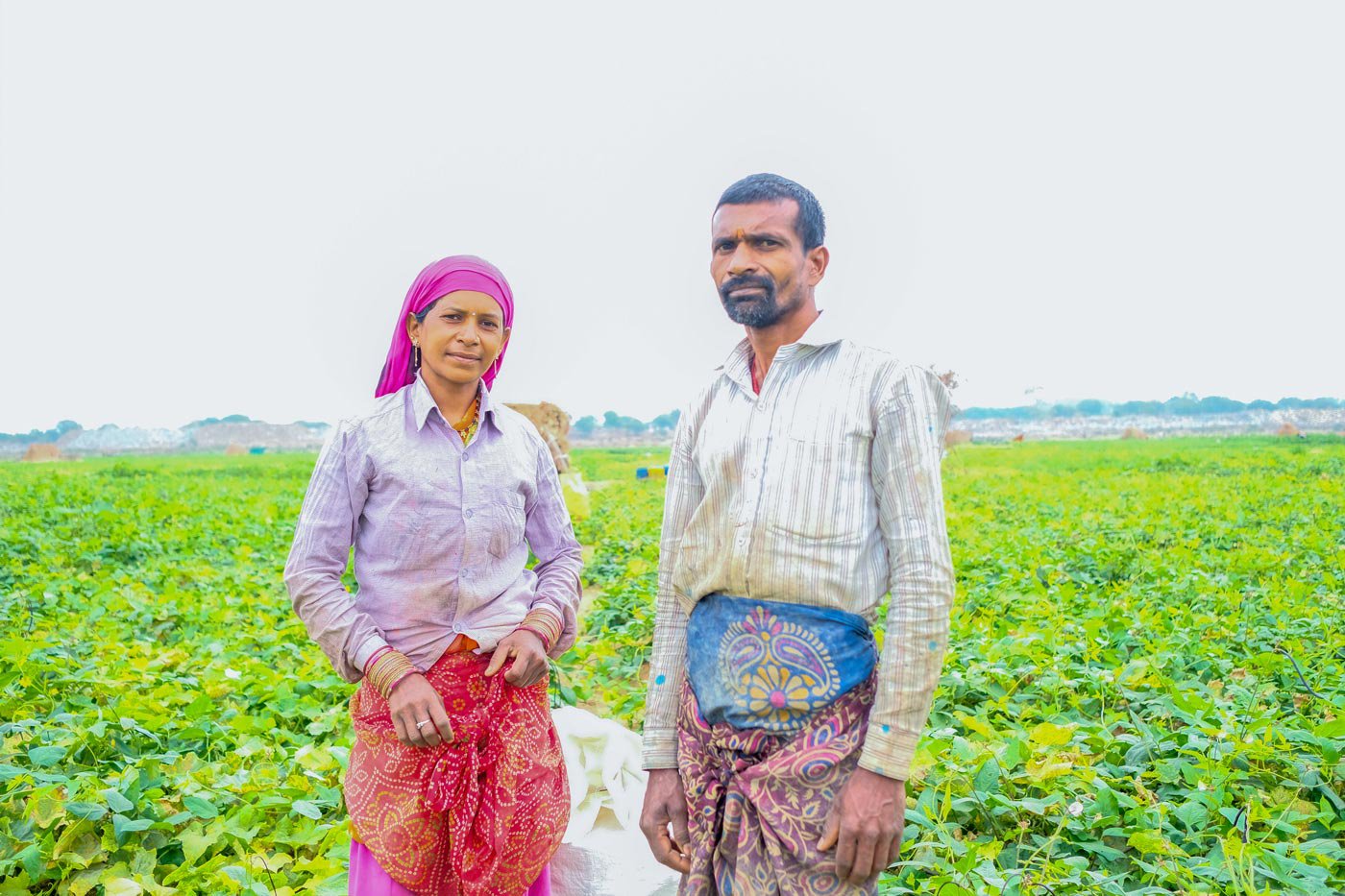 Left: Indraman Chakradhari and Rameshwari Chakradhari standing on their field.
