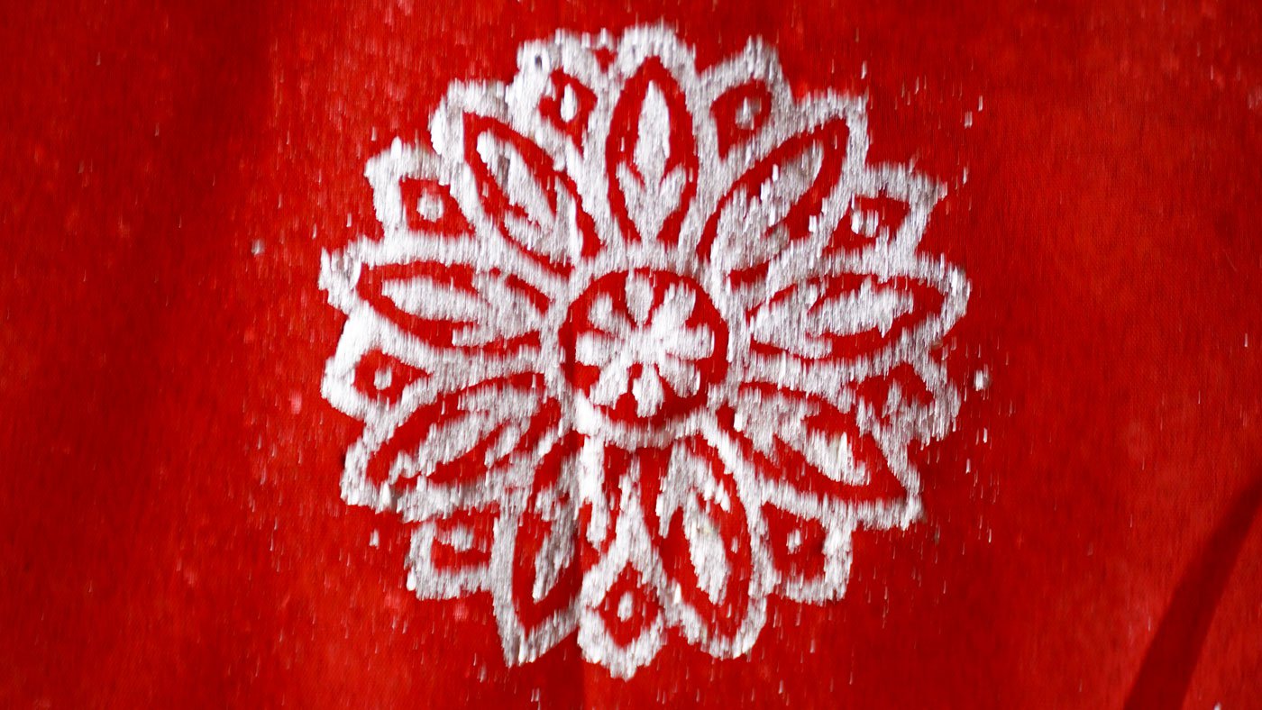 Right: The delicate process is performed swiftly and the design appears on the cloth which now has to be laid out to dry in the sun