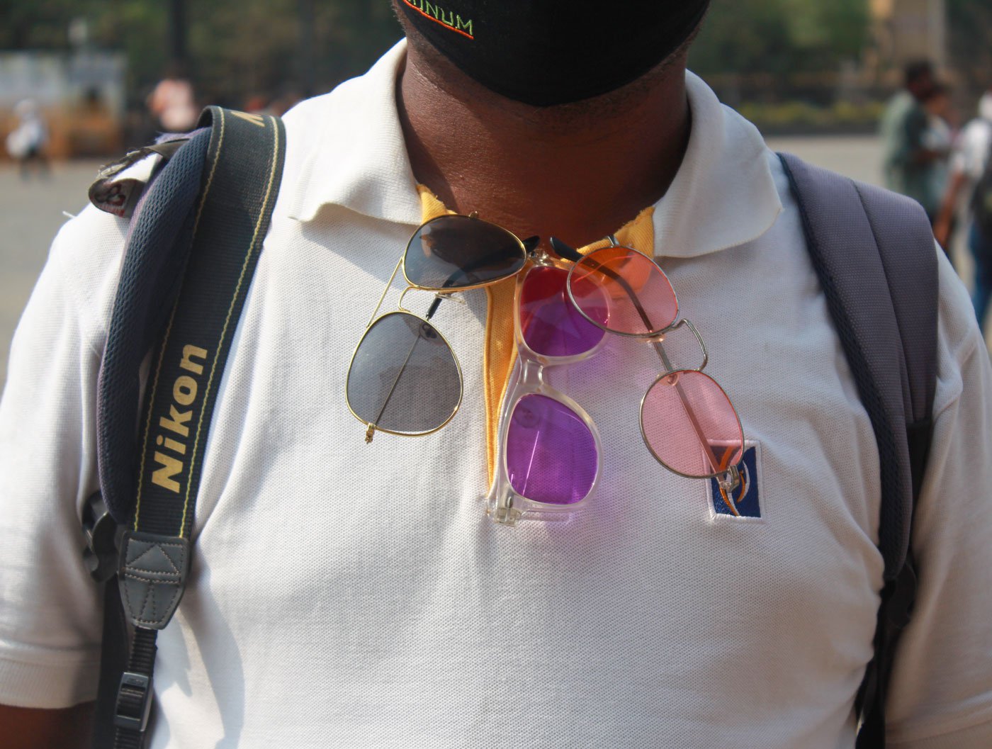 Tools of the trade: The photographers lug around 6-7 kilos – camera, printer, albums, packets of paper; some hang colourful sunglasses on their shirts to attract tourists who like to get their photos clicked wearing stylish shades