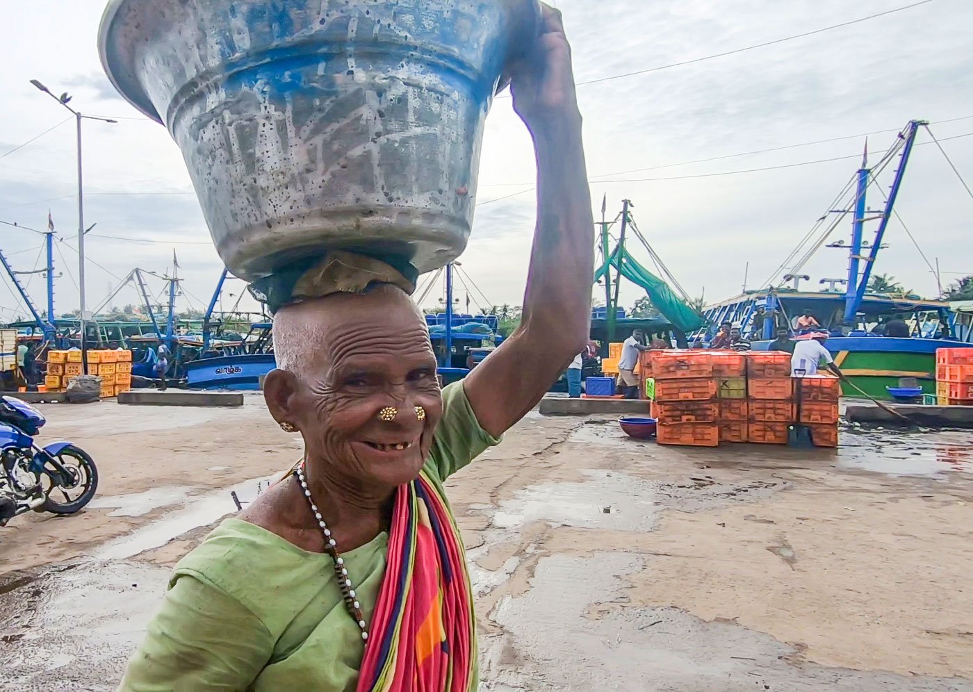 She is at the harbour from 4 a.m. to 6 p.m. – salting, packing selling. The kazhar is salted on the first day to reduce its smell. On the second day it’s dried and packed in mesh bags, which she purchases at the harbour for Rs. 4 each, and sometimes she reuses the jute salt-sacks that cost Rs. 15 each.
One bag of kazhar weighs 25 kilos, says Puli. Earlier, she could sell 4-5 bags a week, but with the Covid-19 pandemic, as well as a ban on ring seine nets, the scale of fish catch and trade has gone down. She now manages to sell two bags a week to to buyers from Namakkal. This brings her a weekly income of about Rs. 1,250.
Women engaged in all tasks – auctioneers, vendors, those drying fish or sorting kazhar – at the Cuddalore harbour speak of the uncertainties of their daily income. Many younger women in the fishing villages prefer to stay away from fisheries. As a result, usually older women work at the harbour.