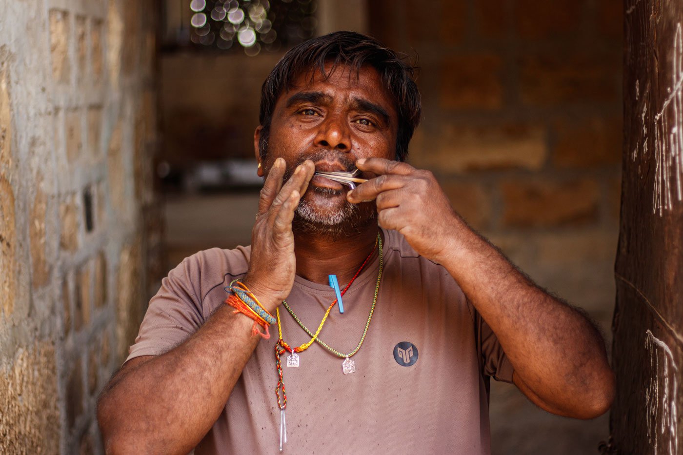 Left: Ranmal, Mohanlal's elder son and a sixth generation lohar, playing the instrument . 'Many people have started using machines for hammering, but we do it using our bare hands even today,' he says.