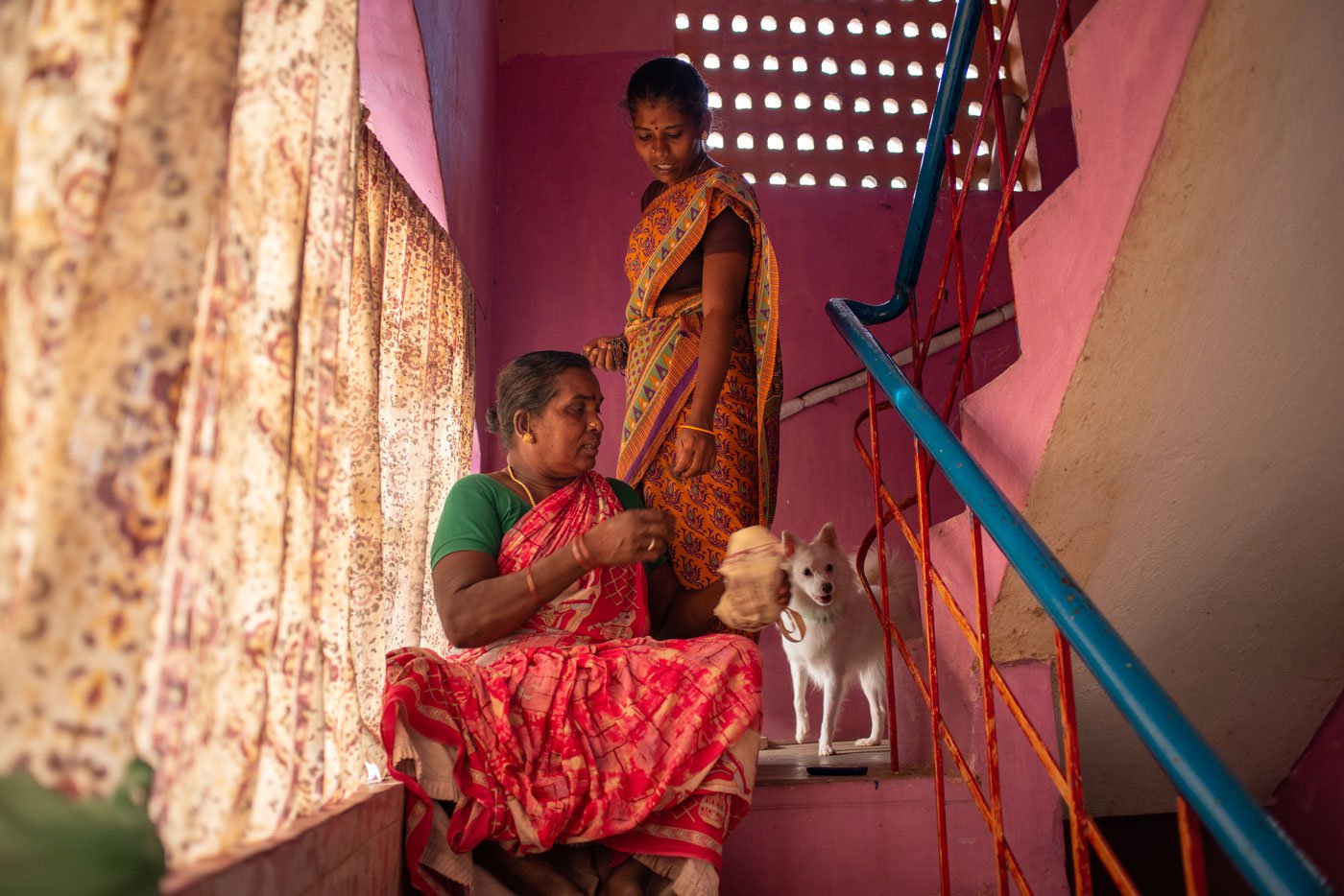 Right: Kavitha and Seetha love dogs. Here, they are pictured talking to their dog