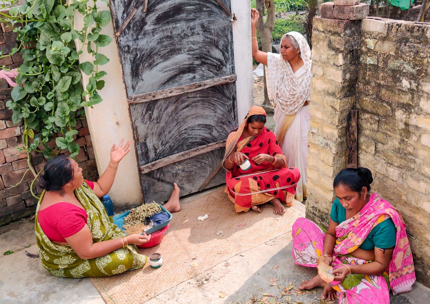 Saida Bewa at the door of the home of beedi workers in Majhpara mohalla, Beldanga where she is speaking to them about their health