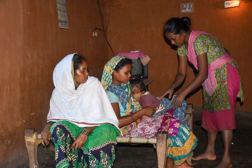 Giving an antimalarial injection to a child