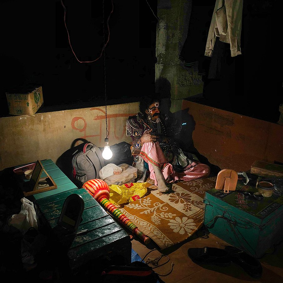 An artist takes a break in a temporary structure