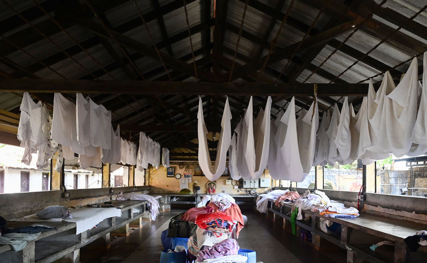 Crisp white laundry drying inside the ironing shed of Dhobi Khana