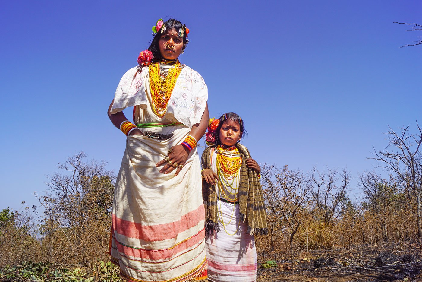 A tribal woman and a young tribal girl in their traditional attire