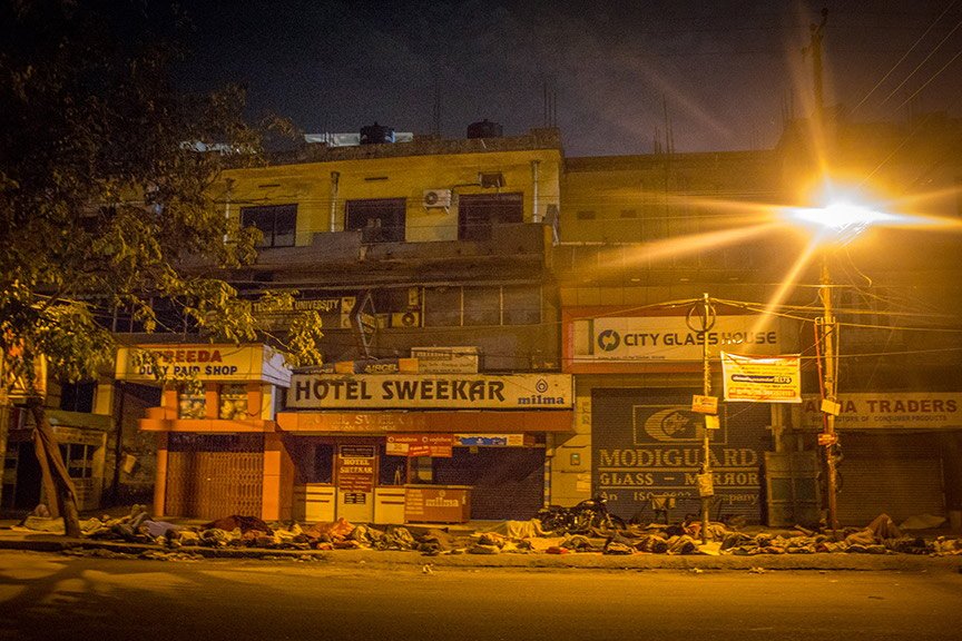 People sleeping on the pavements at Kaloor Junction.