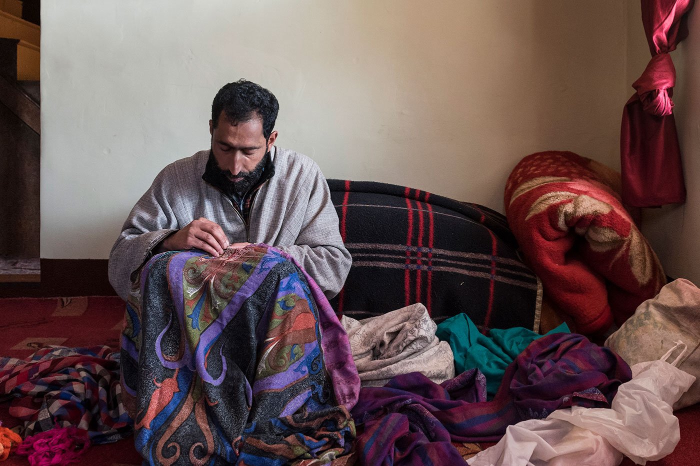 Nazir Ahmed, a master artisan, embroidering a pashmina shawl with his sui-dhaga in Ganderbal. A shawl fully covered with designs can take even up to 6-8 months, while a plain one with an ornate border might take a month at most.