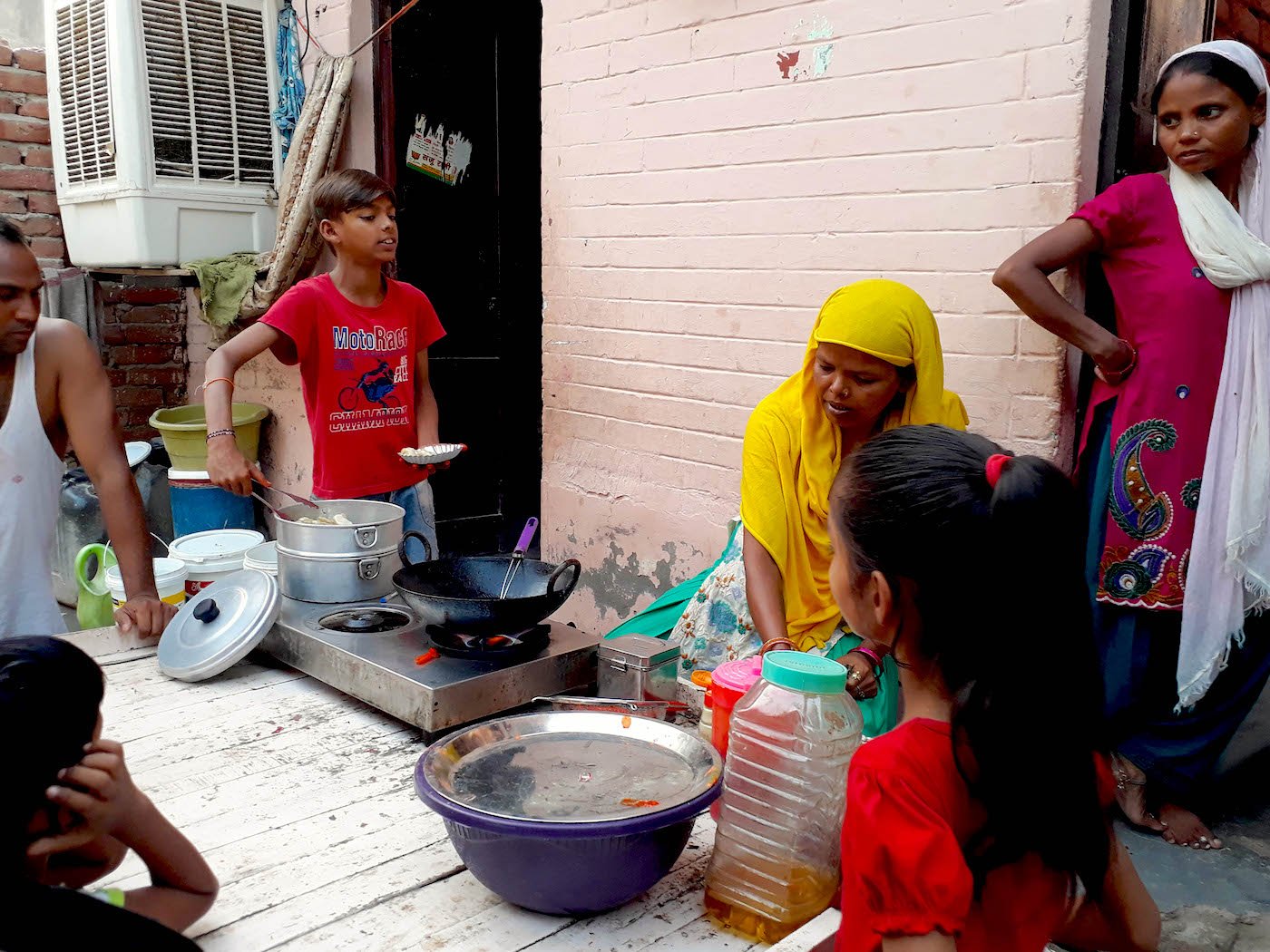 a boy with his family getting his pushcart ready 