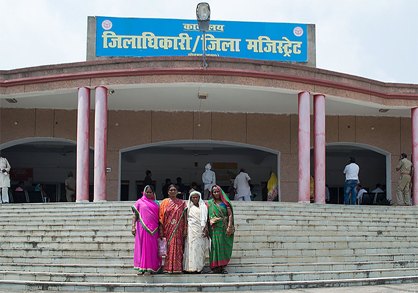Women standing outside district magistrate's office