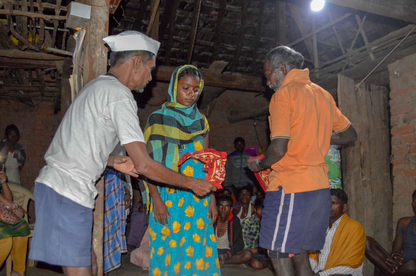Kalu Jangali (left, in a white vest) had confirmed the diagnosis – Nirmala (centre) had jaundice. But, he said, 'She was also heavily under the spell of an external entity', which he was warding off along with fellow bhagat Jaitya Digha during the jagran ceremony in Chikanpada hamlet