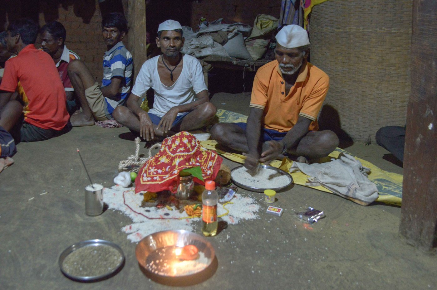 Kalu Jangali (left, in a white vest) had confirmed the diagnosis – Nirmala (centre) had jaundice. But, he said, 'She was also heavily under the spell of an external entity', which he was warding off along with fellow bhagat Jaitya Digha during the jagran ceremony in Chikanpada hamlet