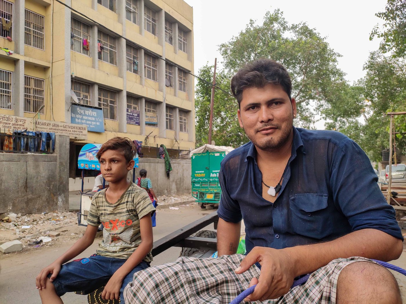'We know the price we pay for living with tradition. But we love our oxen. They are our family', says Vijay Kumar Singh, siting on the cart (left); he never went to school, but wants his son Rajesh (right) to get a good education