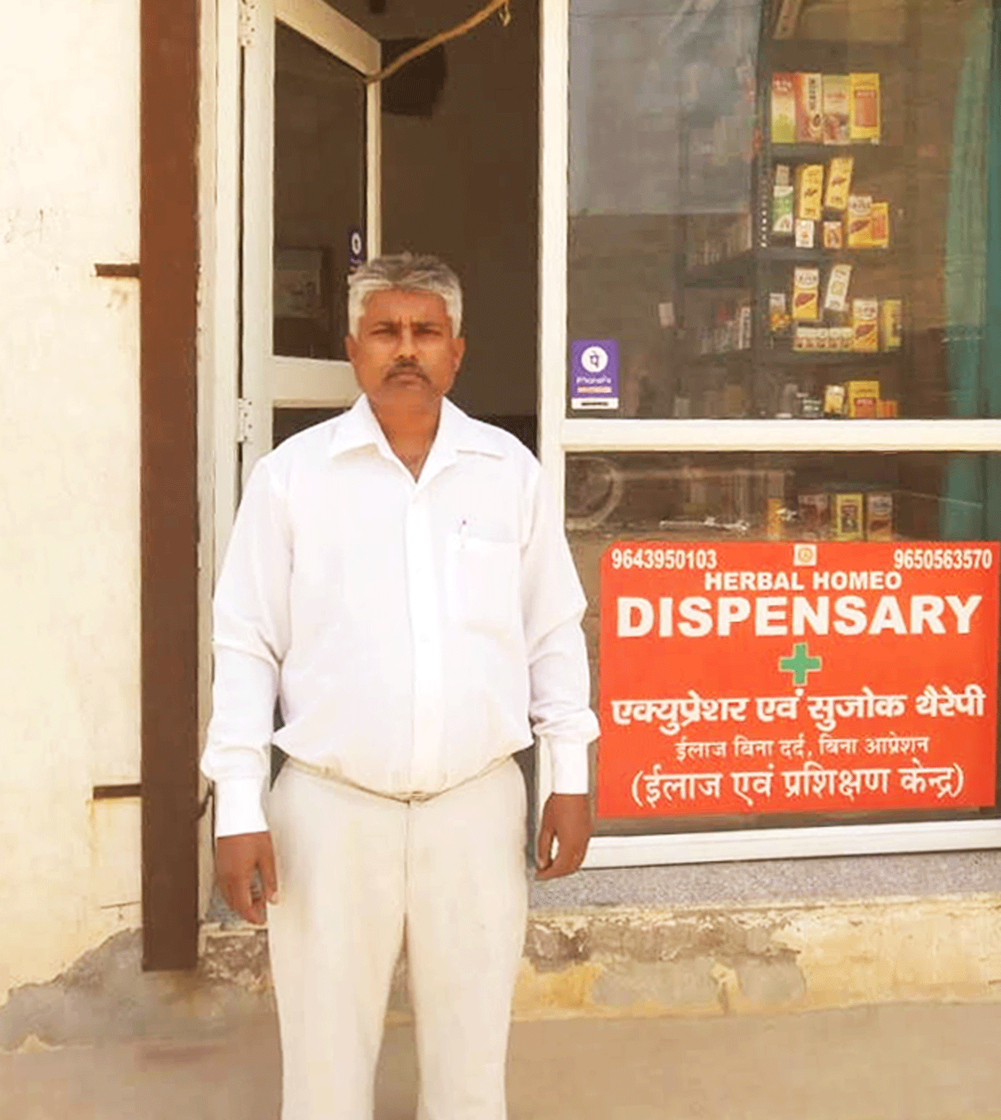 Man poses in front of a dispensary
