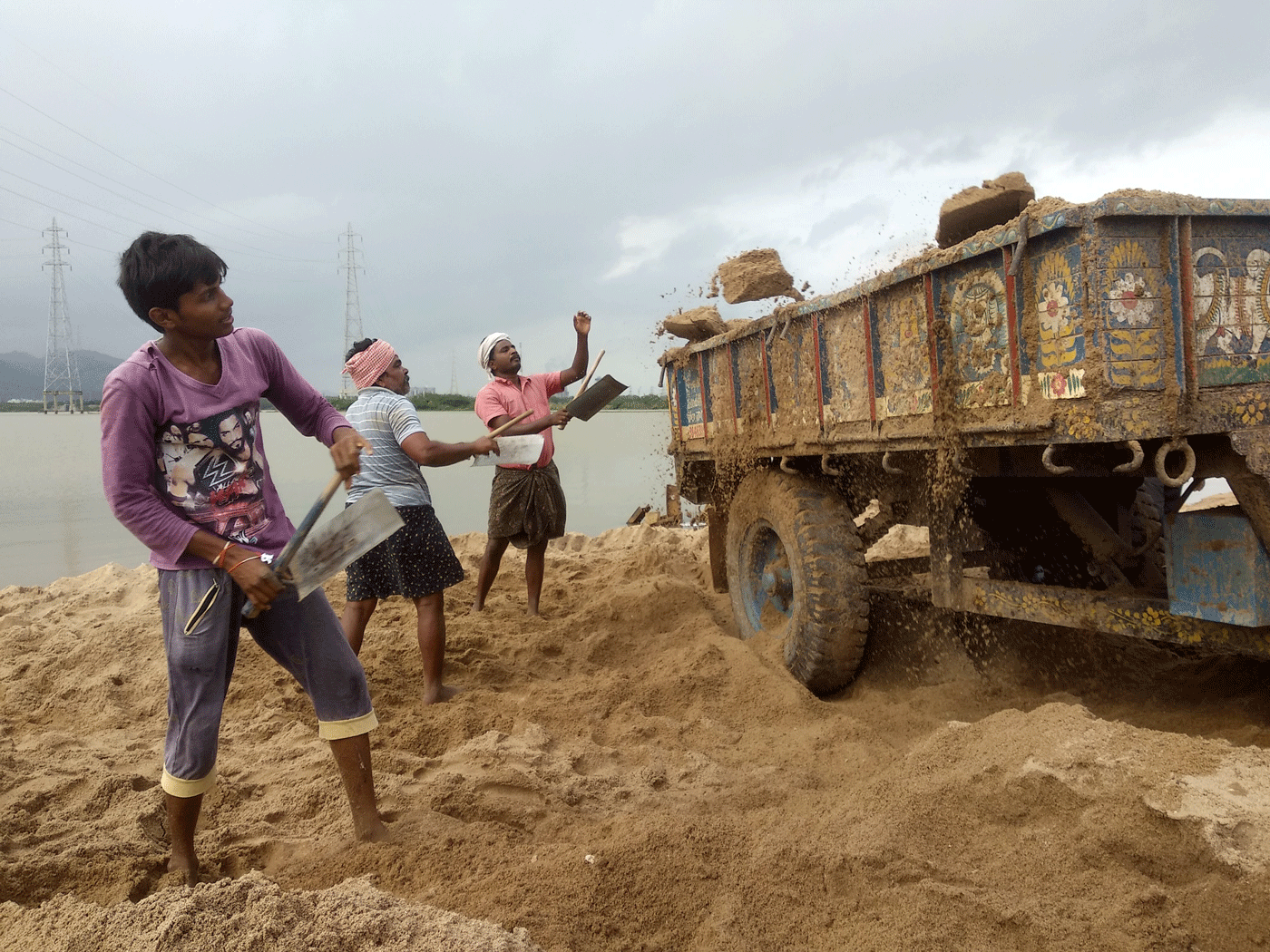 sand getting loaded into trucks