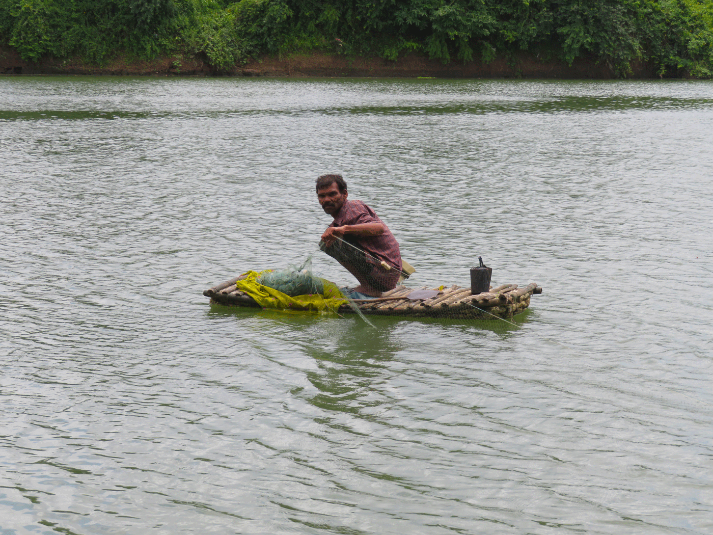 A man in a boat, catching fishes