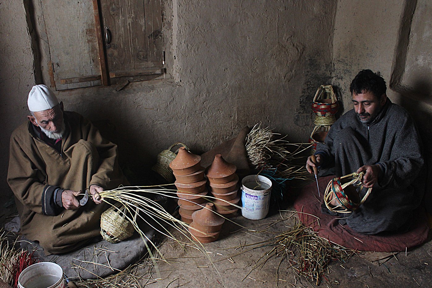 Khazir Mohammad Malik, along with Manzoor Ahmad, weaving kangris at his workshop in Charar-i-Sharief
